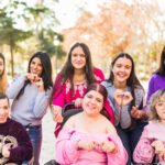 Diverse empowered gender equality feminist friends together doing a 8th march celebration. Inclusion and sorority with cerebral palsy friendship on electric wheelchair.